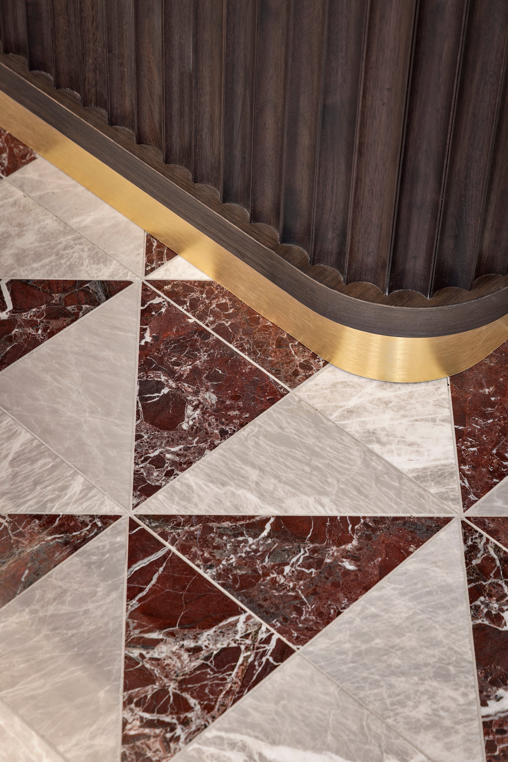 Marble flooring and custom wood detailing in the Hotel Modo lobby