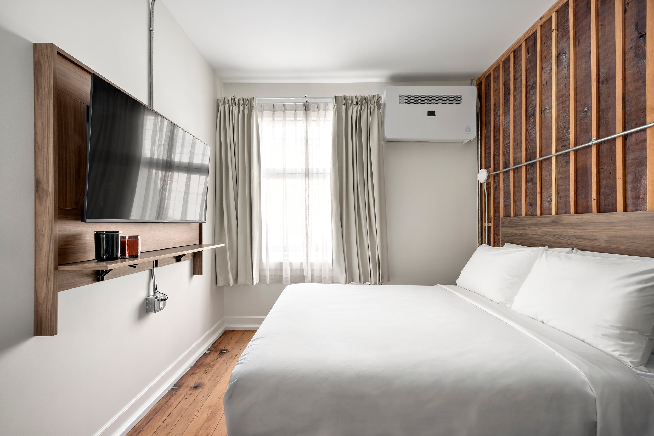 Compact guest room at Hotel Modo with original exposed wood details